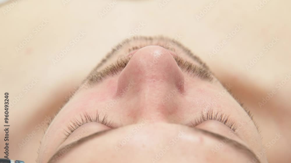 A man undergoes hydrofacial vacuum facial cleansing, rejuvenation, moisturizing facial procedure in a beauty clinic. Beauty and youth concept A man undergoes hydrofacial vacuum facial cleansing, rejuvenation, moisturizing facial procedure in a beauty clinic. Beauty and youth concept