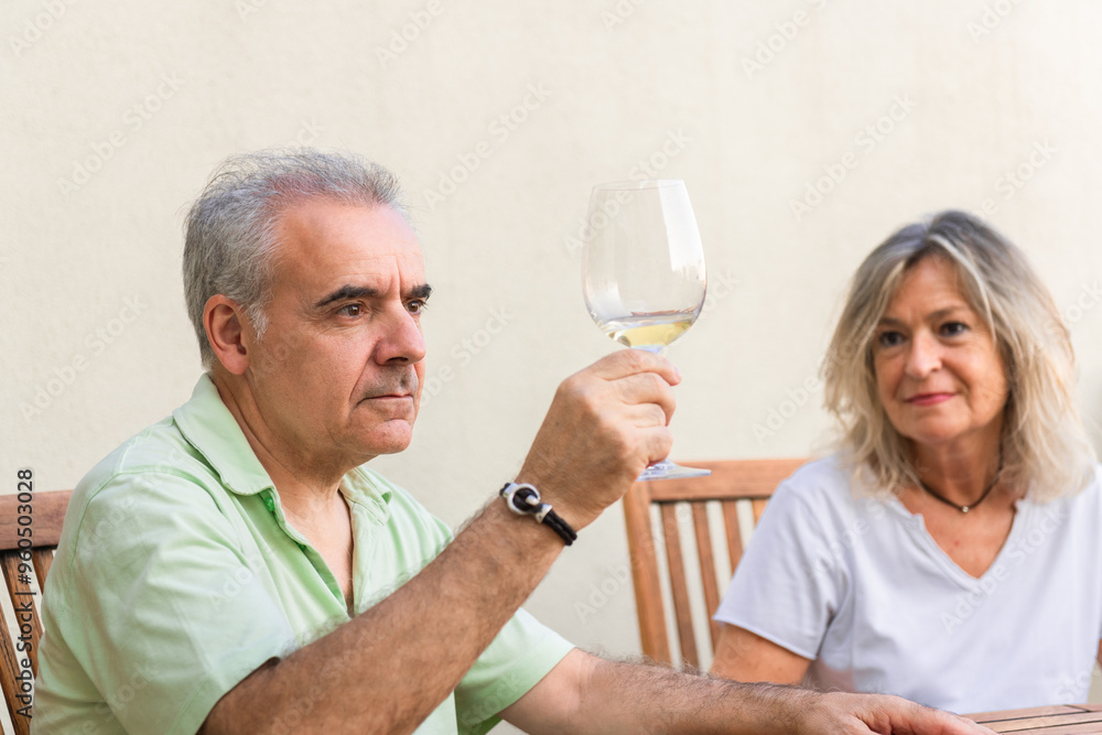 Mature couple enjoying white wine outdoors Mature couple enjoying white wine outdoors