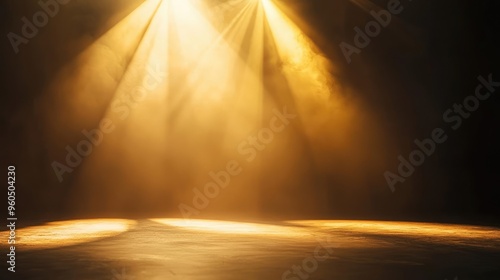 Golden light beams illuminate a dark stage, creating a dramatic and atmospheric setting for performances or events.