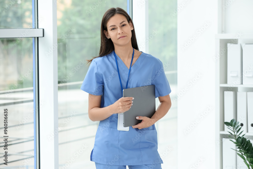 Beautiful nurse with laptop in hospital office Beautiful nurse with laptop in hospital office