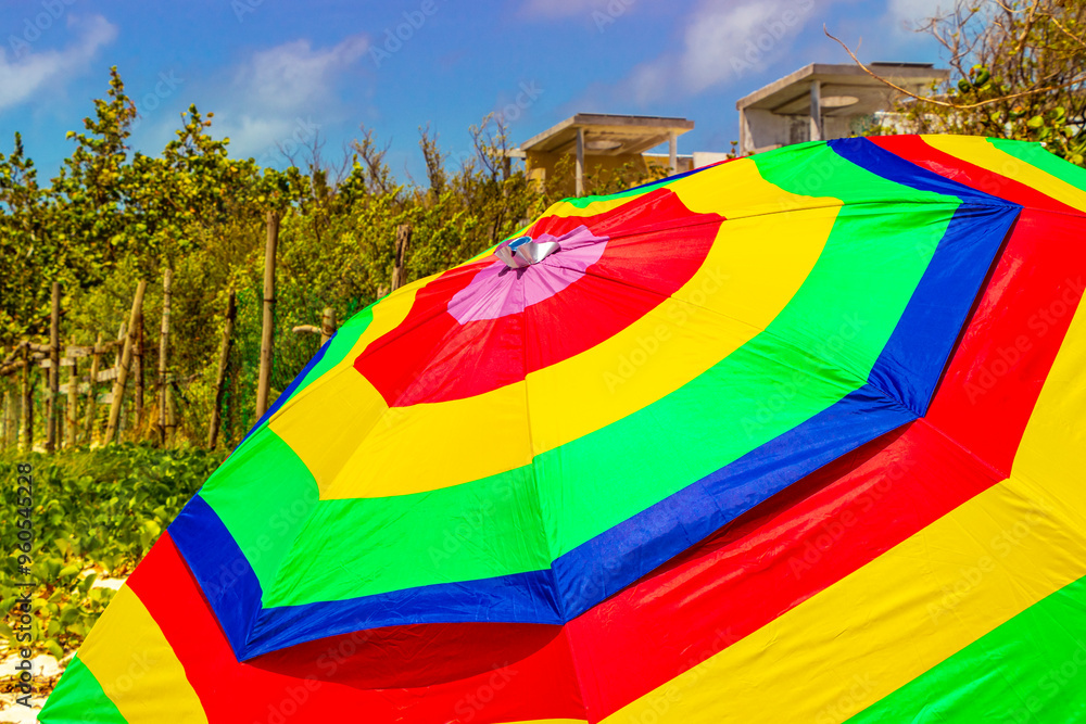 Colorful parasol with blue sky on the Caribbean beach in Mexico. Colorful parasol with blue sky on the Caribbean beach in Mexico.