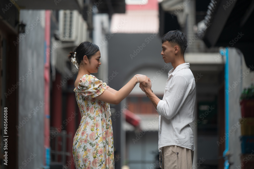 Obraz premium Young Asian Couple enjoying and walking holding hands at street