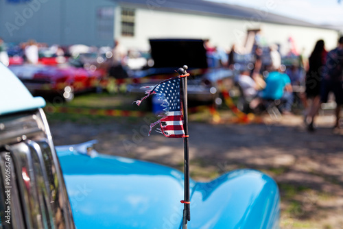 torn American flag on hood at car show photo