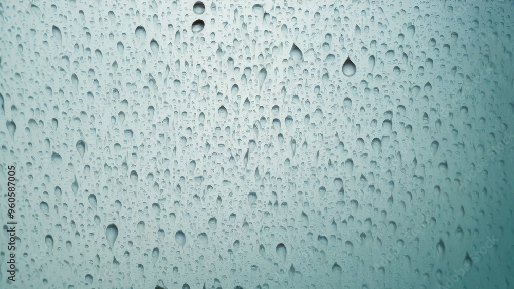 Water droplets slide across the glass surface. Water droplets slide across the glass surface.