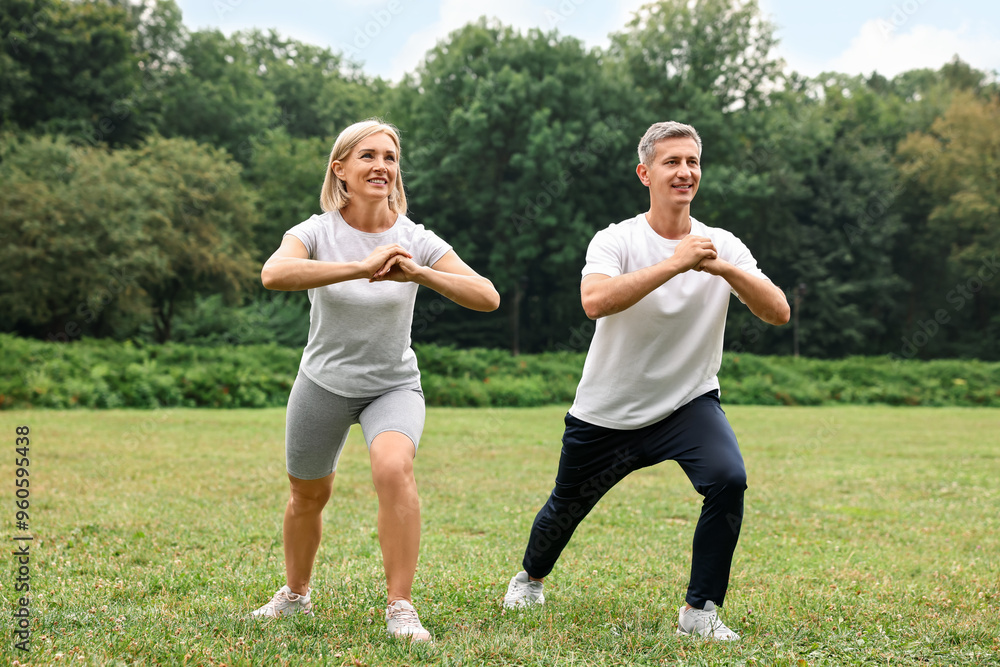 Happy couple doing exercises in park. Healthy lifestyle Happy couple doing exercises in park. Healthy lifestyle