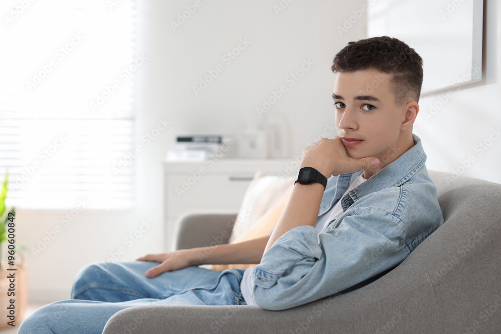 Portrait of teenage boy on sofa at home. Space for text Portrait of teenage boy on sofa at home. Space for text