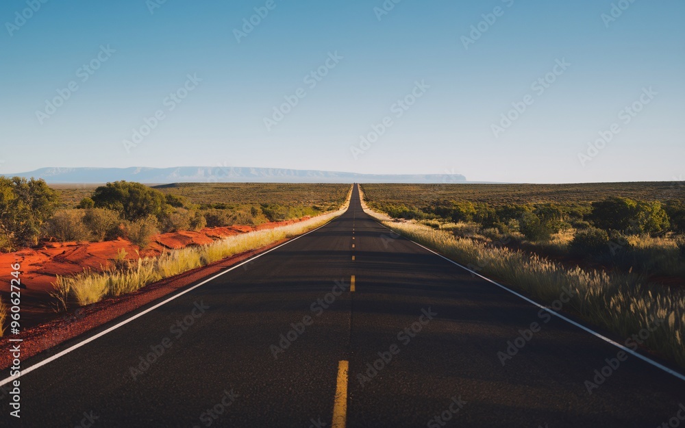 Obraz premium Australian Outback Road with Space for Text Under a Clear Blue Sky