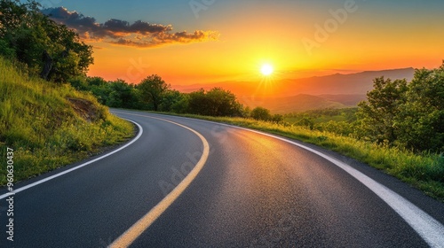 Wide view of an empty road curving under the setting sun