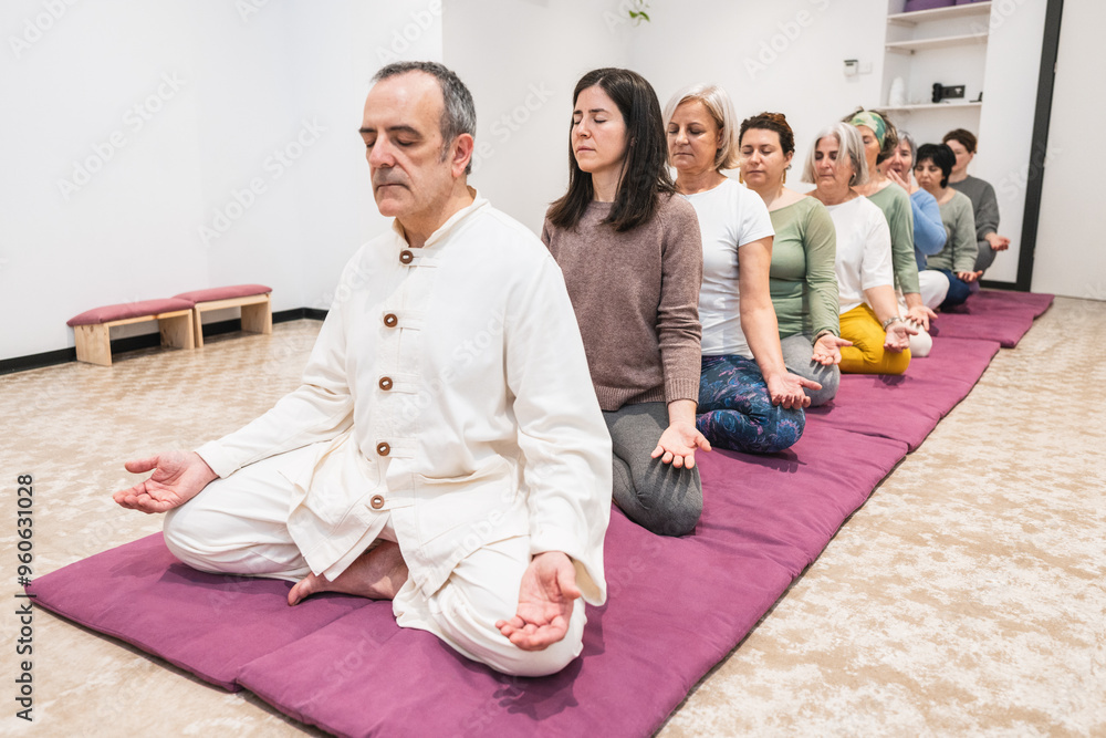 Yoga instructor and senior women in seated meditation during mindfulness session. Yoga instructor and senior women in seated meditation during mindfulness session.