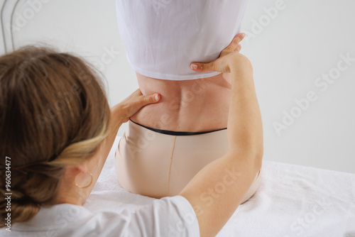 Photography a therapist rehabilitation specialist checks the mobility of the spinal arches,
