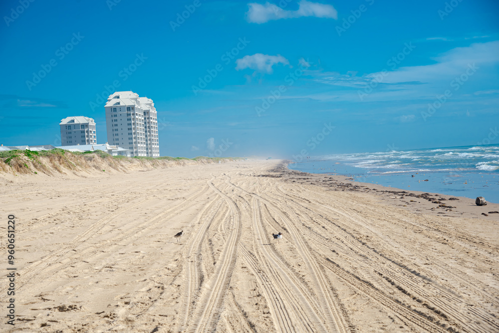 Multistory beach condo, high-rise apartment building along white sandy ...