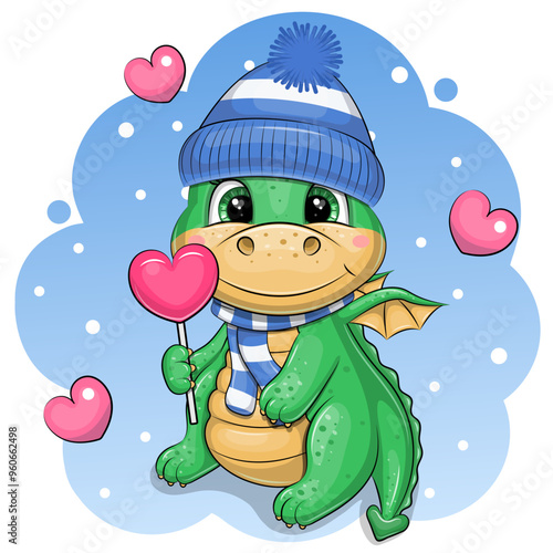 A cute cartoon green dragon in a warm hat and scarf is holding a heart-shaped lollipop. Vector illustration of an animal on a blue background with white dots and pink hearts.