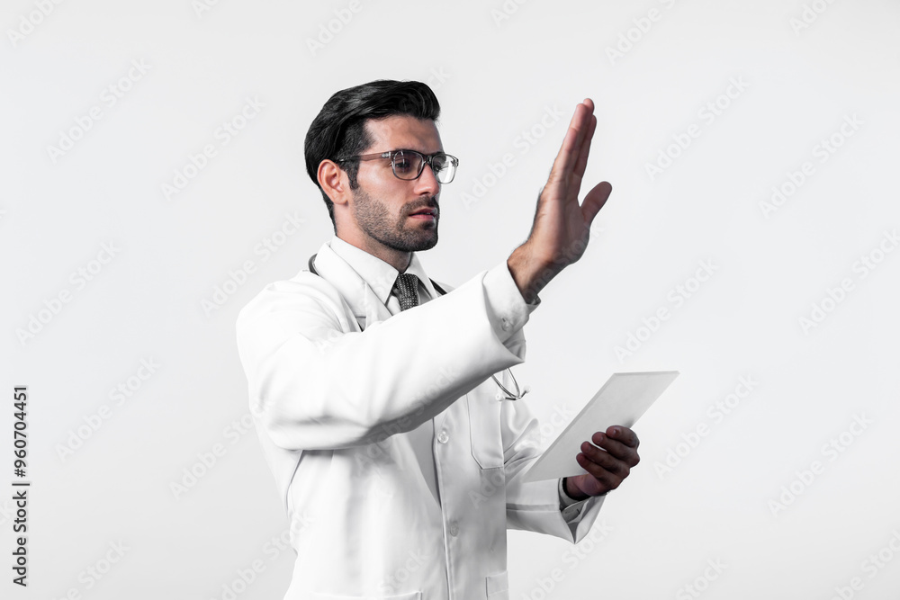 Caucasian smart doctor pointing finger while standing at white background and wearing lab coat. Skilled specialist doctor using medical technology while pointing and holding health data. Deviation. Caucasian smart doctor pointing finger while standing at white background and wearing lab coat. Skilled specialist doctor using medical technology while pointing and holding health data. Deviation.