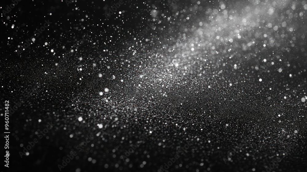 Obraz premium A mesmerizing display of sparkling dust particles against a dark background, creating a magical atmosphere.