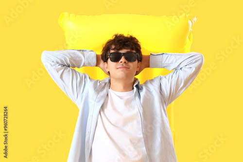 Young man with swim mattres...