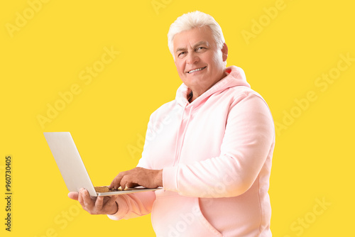 Senior man using laptop on ...