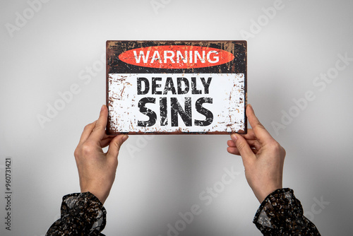 фотографія Deadly Sins. Warning sign with text on a white background