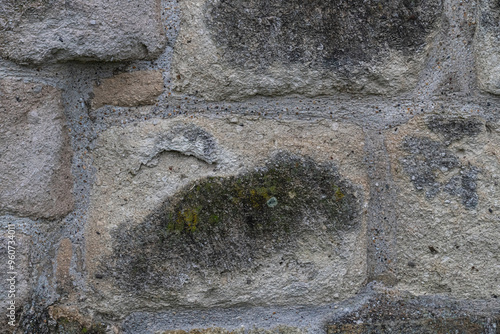 gray stone wall of the castle close-up, background of large cobblestones photo