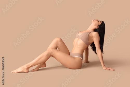 Young woman in underwear si...
