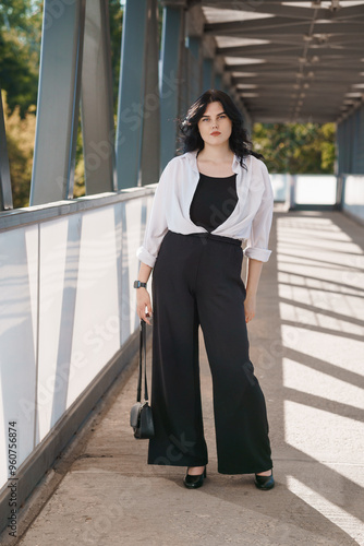 Confident Business Professional in Modern Attire on Urban Bridge