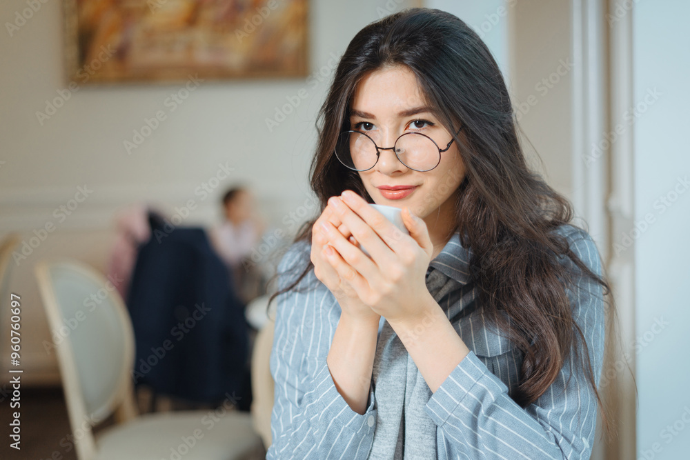 Portrait of attractive young woman relaxing in cafe and drinking tea Portrait of attractive young woman relaxing in cafe and drinking tea