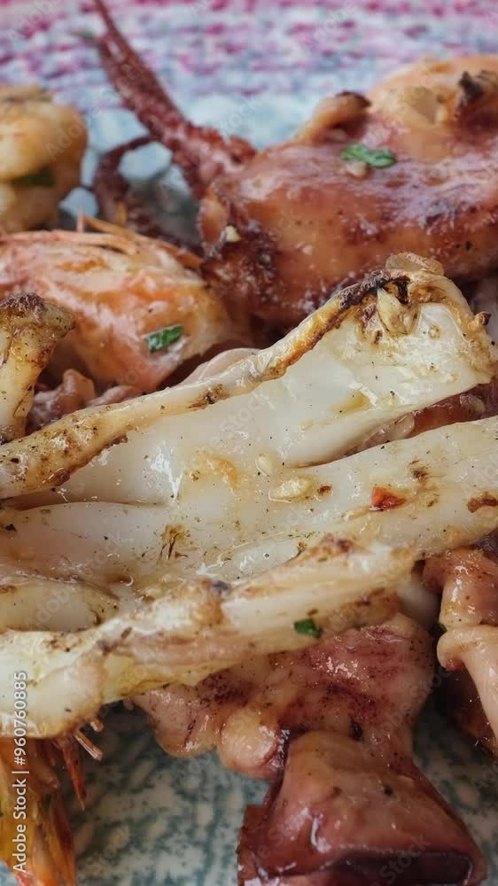 seafood squid and octopus on a plate on the beach with lemon delicious cooked in tropical country. travel food seafood squid and octopus on a plate on the beach with lemon delicious cooked in tropical country. travel food