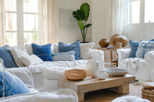 white& blue color seaside cottage theme decoration in comfortable living room with pluffy sofa in water view apartment next to the beach photo