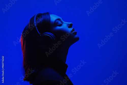 Elegant Woman in Black Headphones with Solid Neon Blue Details, Captured in a Contemporary Lifestyle Portrait