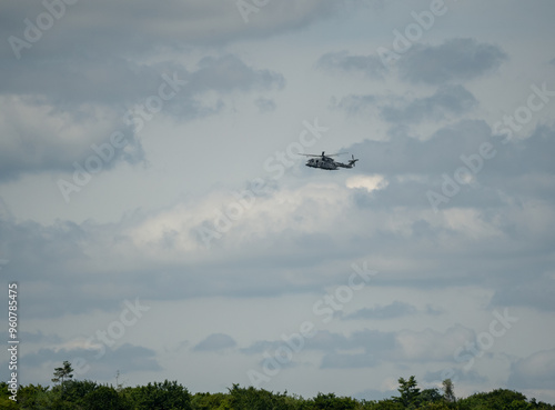 large agustawestland AW101 grey helicopter flying in a cloudy sky photo