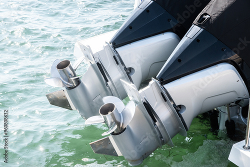 Outboard engine propeller on motorboat closeup on sea waters background photo