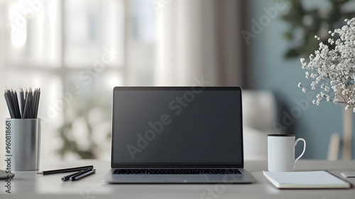 Wallpaper Mural Laptop mockup on an organized work desk with notebooks, pens, and a coffee cup in a cozy, modern office space. Torontodigital.ca