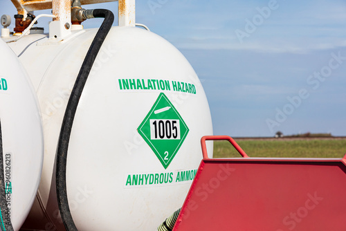 Anhydrous ammonia tank in farm field. Agriculture fertilizer application, costs and farmer safety concept. photo