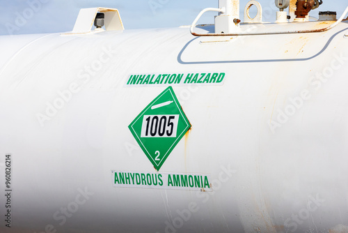 Anhydrous ammonia tank in farm field. Agriculture fertilizer application, costs and farmer safety concept.