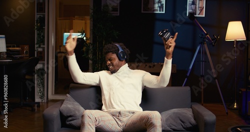 Valokuva BIPOC player shouting after losing while playing online multiplayer videogame, frustrated by unhelpful teammates