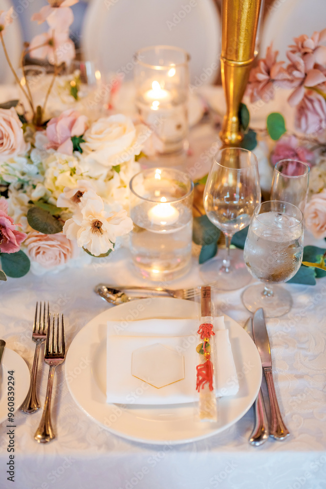 Beautiful table in a restaurant decorated with flowers and candles. Plate and cutlery with chopsticks. Beautifully set table waiting for guests in a restaurant Beautiful table in a restaurant decorated with flowers and candles. Plate and cutlery with chopsticks. Beautifully set table waiting for guests in a restaurant