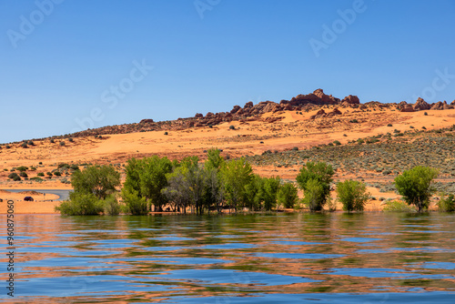 Red ssandstone formations and  inviting blue water are in abundance at Sand Hollow State Park near St George, Utah.