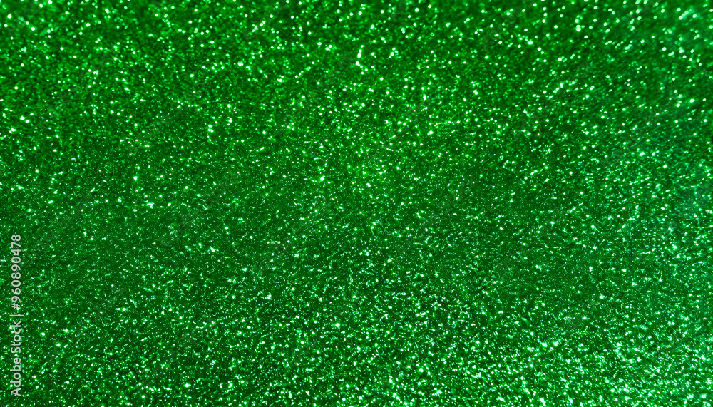 Fototapeta premium green glitter texture, filling the entire frame with a rich, bold, and sparkling surface that offers a striking and vibrant pattern.