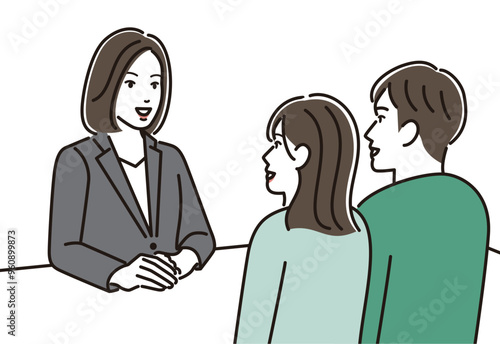 説明するスーツの女性と説明を受ける夫婦