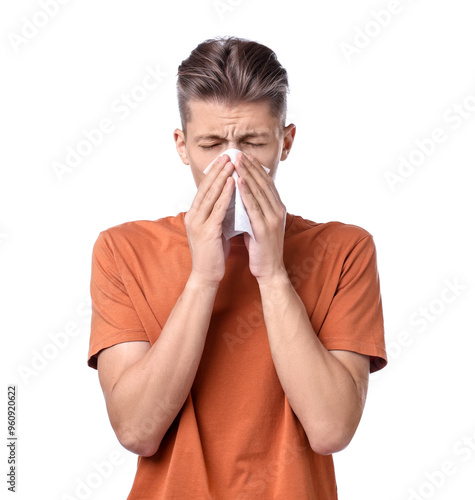 Young man with tissue suffering from sinusitis on white background