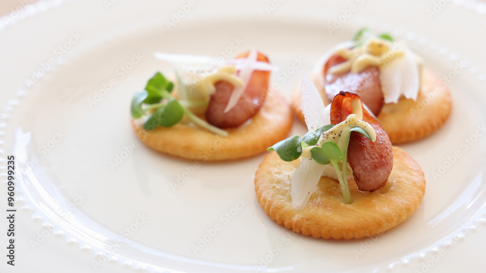 Canapé party appetizer with sausage and cream cheese on crackers Canapé party appetizer with sausage and cream cheese on crackers