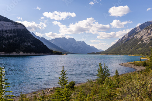 Scenic Mountain Lake View in Kananaskis, Alberta with Majestic Rocky Mountains and Blue Sky