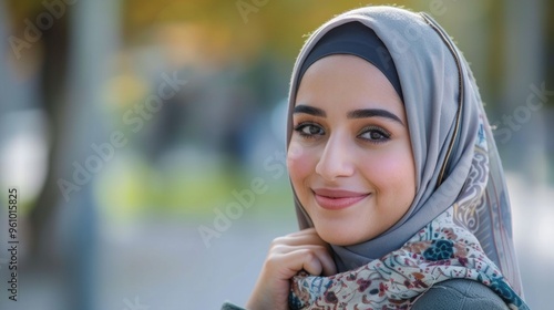 Portrait of young Asian muslim woman wearing hijab head scarf on street in the city