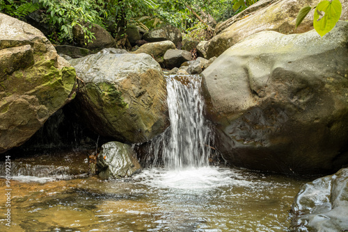 Beautiful small waterfall flowing between rocks in the middle of the jungle