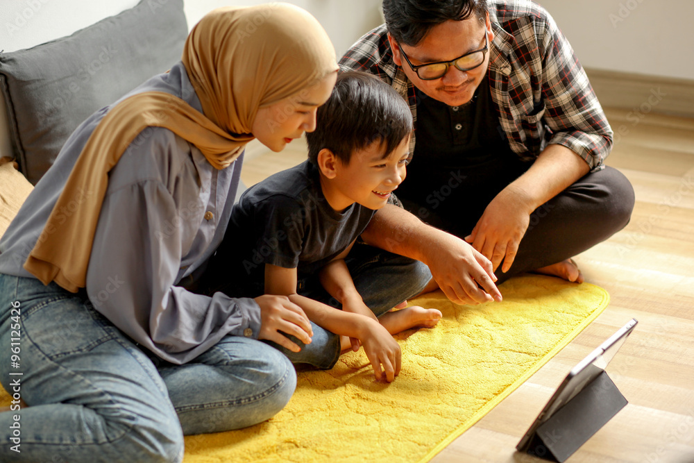 Family Bonding And Parenting Father, Mother And Son Watching Movie Together Using Digital Tablet At Home Family Bonding And Parenting Father, Mother And Son Watching Movie Together Using Digital Tablet At Home