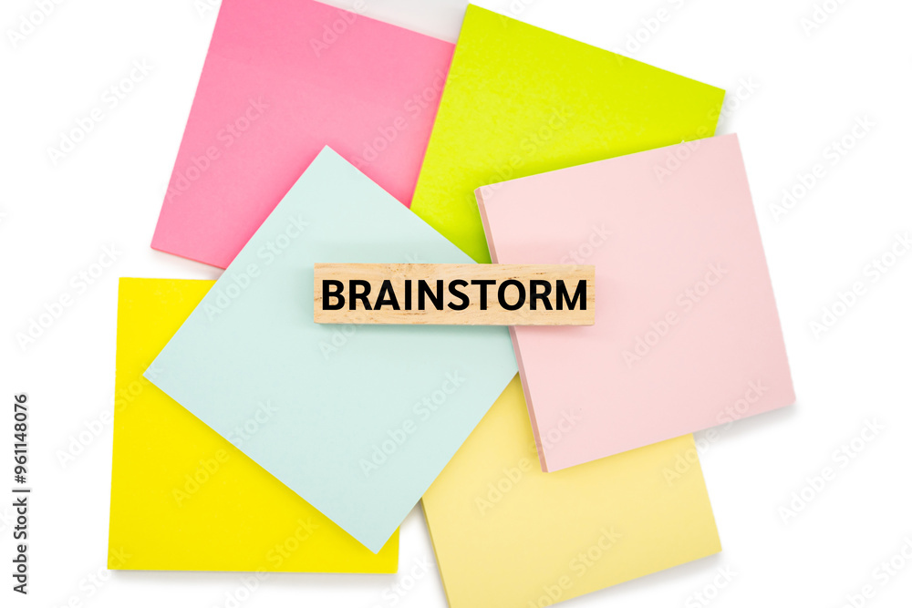BRAINSTORM text wooden block on sticky note. Business concept. Education concept. BRAINSTORM text wooden block on sticky note. Business concept. Education concept.