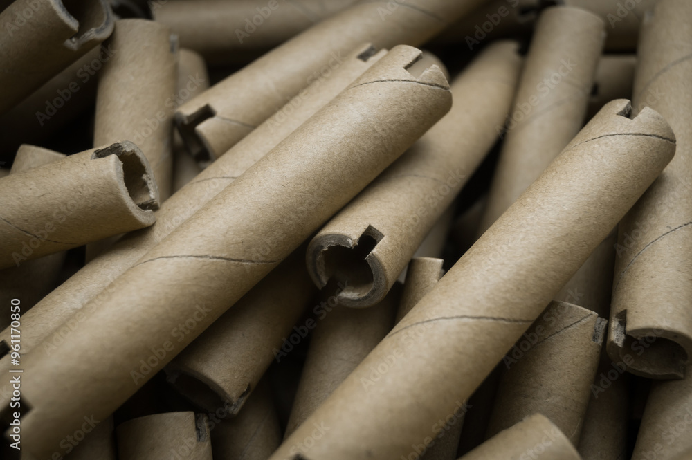 Special cardboard cores for winding paper and film tapes. Paper tubes for winding the products of printing houses. Cardboard tubes. Selective focus Special cardboard cores for winding paper and film tapes. Paper tubes for winding the products of printing houses. Cardboard tubes. Selective focus