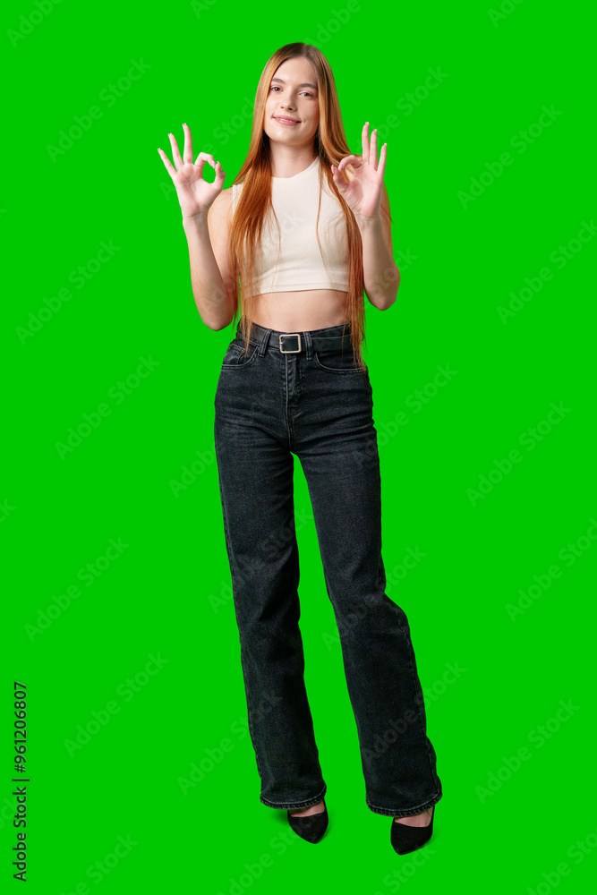 Young Woman With Long Hair Gesturing Okay Sign in Front of Green Screen Young Woman With Long Hair Gesturing Okay Sign in Front of Green Screen