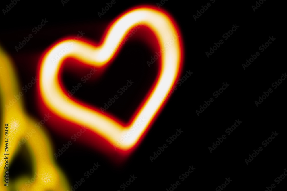 A heart is lit up in a black background. The heart is surrounded by a yellow glow. The heart is the main focus of the image A heart is lit up in a black background. The heart is surrounded by a yellow glow. The heart is the main focus of the image