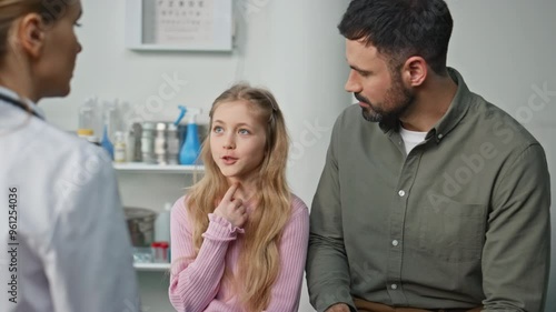 Sick girl talking pediatrician in clinic closeup. Ill kid describing symptoms
