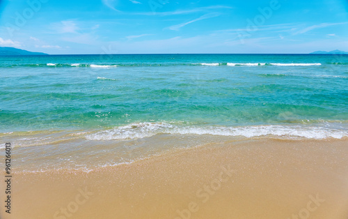 Azure sea waves on the sand beach.